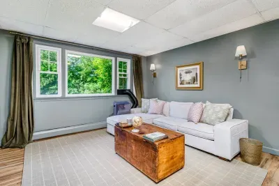 lower level offers a second TV, game table, and PS4. The primary bedroom also includes a quiet reading nook.