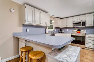 Fully Equipped Kitchen: Everything you need to cook and dine in—stocked with cookware, dishes, utensils, and modern appliances. The dining table seats six, plus bar seating for four.