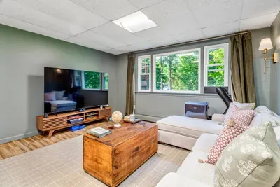 lower level offers a second TV, game table, and PS4. The primary bedroom also includes a quiet reading nook.