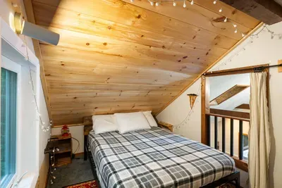 Cozy loft bedroom with cabin vibes.