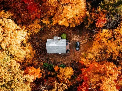 Aerial view of the house, surrounded by trees