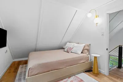 Upstairs, you’ll find another queen bedroom with a dedicated workspace