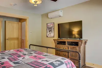 Bedroom 2 with king size bed, dresser and TV