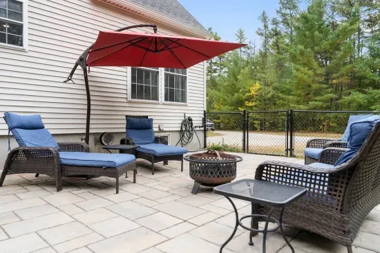 Relax on the patio with comfy seating and a fire pit.