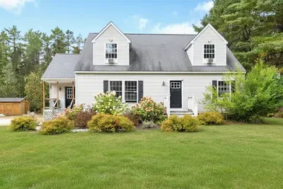 Inviting home with a beautiful, open yard.