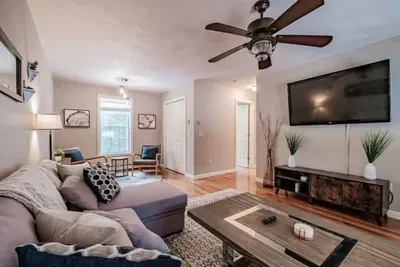 Bright and spacious with comfy sofas, an electric fireplace, smart TV, and window AC for warm summer days.rge TV