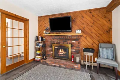Huge TV with an indoor fireplace