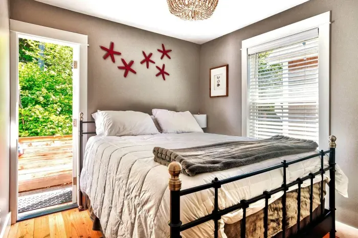 Primary bedroom on main floor with queen bed and direct access to private patio and hot tub