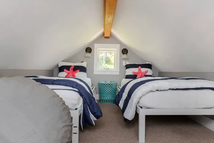 Twin beds in the Captains Loft with a comfy bean bag chair to relax and read 