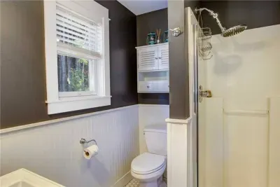Modern bathroom with a rainhead shower—essential for a coastal retreat.