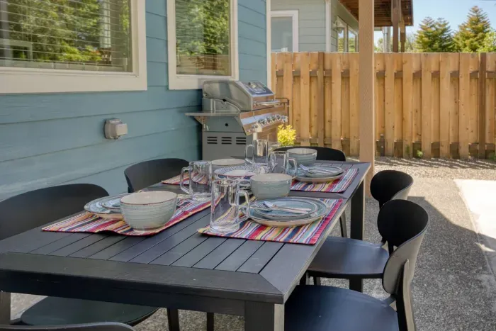 Al fresco dining at its finest! Enjoy meals straight off the stainless steel gas BBQ grill at our outdoor dining table, perfectly set up on the private back patio for sunny coastal days.