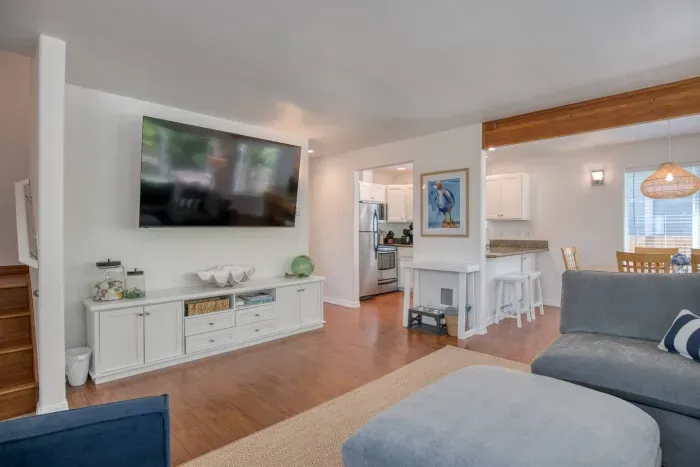 Relax and unwind in the cozy living area! Features a large flat-screen Smart TV, a media console packed with games on both sides, a big comfortable sectional, and easy access right into the kitchen.