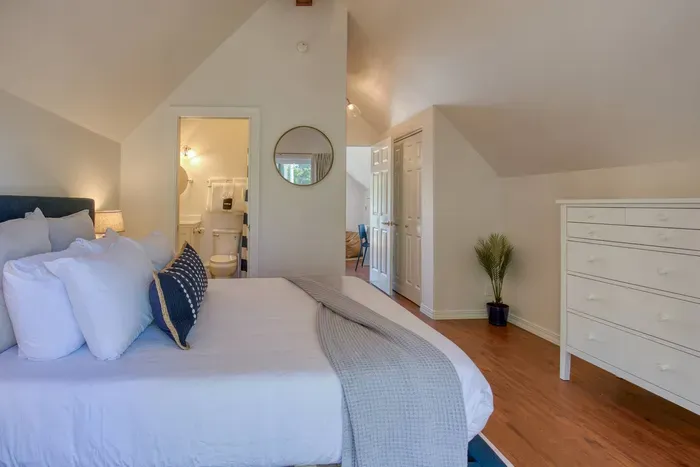 Private upstairs suite boasting a Queen bed, vaulted ceilings, and direct access to your private balcony