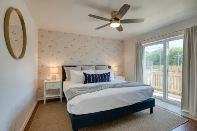 Relax in comfort! Downstairs King bedroom complete with a flat-screen Smart TV and cozy coastal touches.