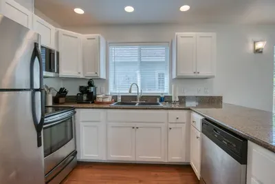 The heart of the cottage! Enjoy a completely stocked kitchen featuring a microwave, dishwasher, coffee maker, and plenty of prep space just off the living area.