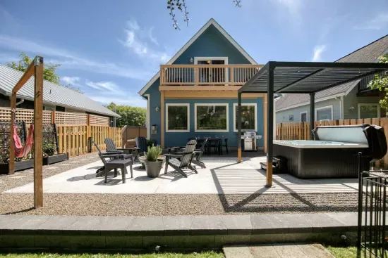 Relax on the private back patio, complete with a hot tub, comfortable lounge seating, a gas fire pit, and hammocks. Fully fenced for your privacy!