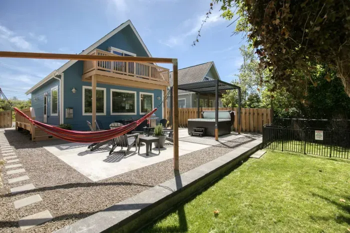 The perfect backyard retreat: unwind in the hot tub or hammock while your pups enjoy the dedicated, secure dog run.