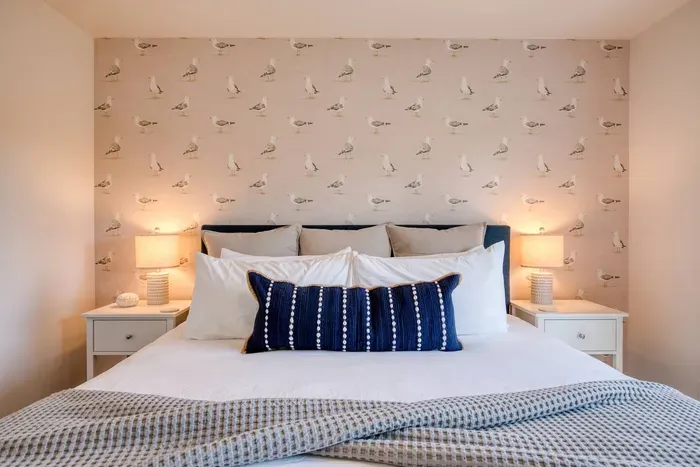 Relax in comfort! Downstairs King bedroom complete with a flat-screen Smart TV and cozy coastal touches