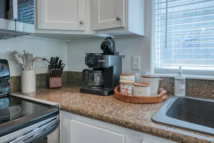 Fuel your beach mornings! Our dedicated coffee station features a versatile Keurig K-Duo maker for single cups or full carafes, complete with mugs and matching canisters stocked with everything you need for the perfect brew