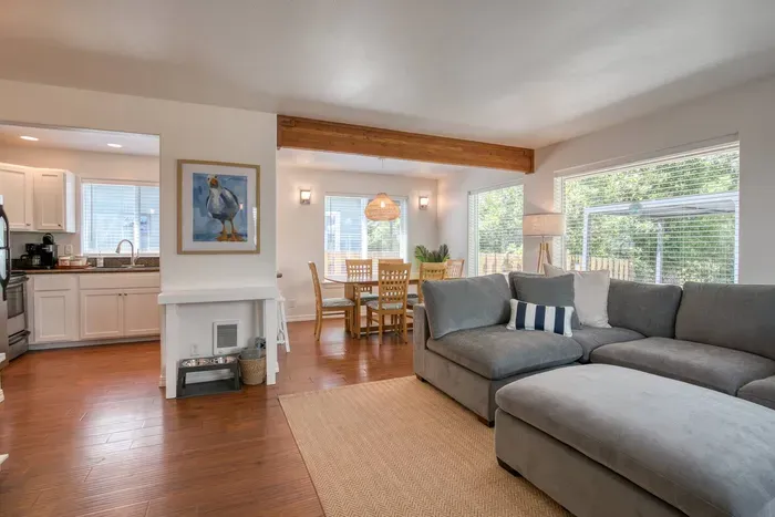 Welcome to our bright, open-concept living space! Perfect for groups! This space connects the kitchen and living room, offering three island stools, a large sectional, and an extra lounge chair so everyone has a comfortable spot to relax.