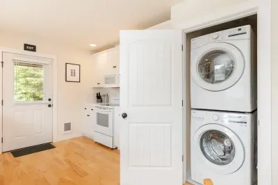 Brand new full-size washer and dryer with detergent provided—perfect for cleaning up after a family day at the beach.