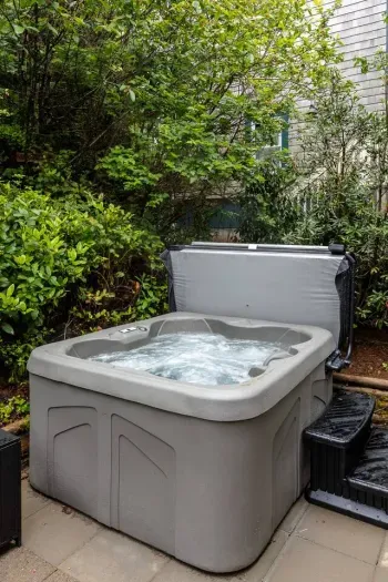 Your 4 person hot tub among the trees on your private patio