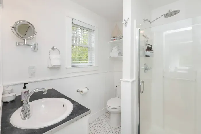 Modern bathroom with a rainhead shower and provided spa towels.