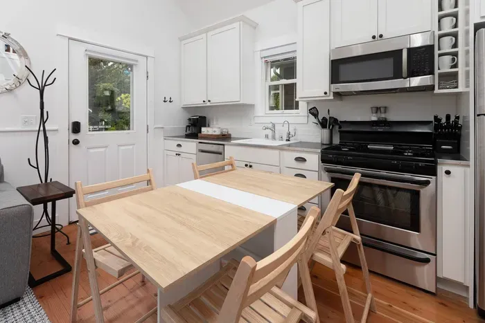 Dining table can fold up and down to accommodate two to four guests 