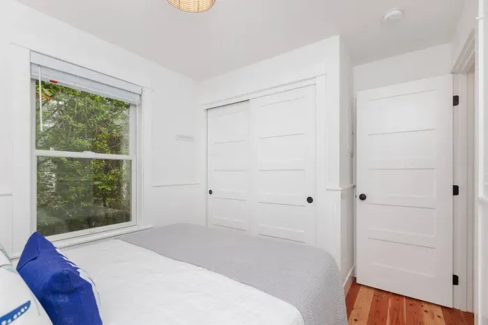 Primary bedroom on the main floor with queen bed. Ample storage for clothing, and luggage in the closet.