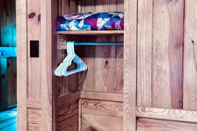 Closet with hangers and extra quilt