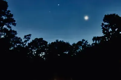 Night view of F-CATCH YA LATER! from our docks. The bright ball of light in the sky is Venus.