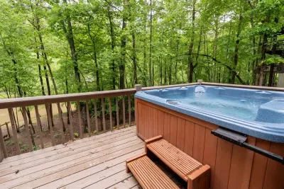 Hot tub overlooking the river next to the fire pit