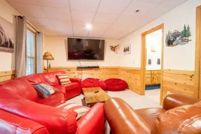 Basement level living room with 75" TV to enjoy sports or movies.