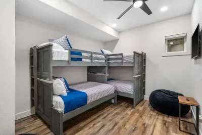 A pair of twin-over-full bunkbeds awaits in the fifth bedroom sanctuary