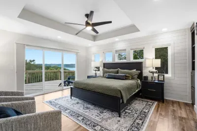 The primary king suite boasts a luxe private ensuite, deck access, & smart TV