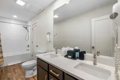 This king ensuite features a double vanity & shower/tub combo