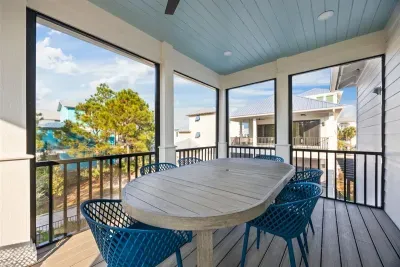 Screened dining porch at Anchor Down by the Dunes (guest house)