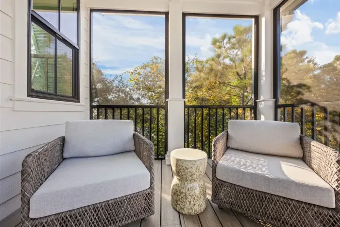 Screened porch seating at Anchor Down by the Dunes (guest house)