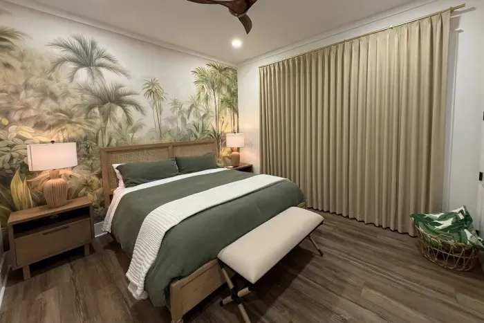 Primary bedroom with king bed, blackout drapery