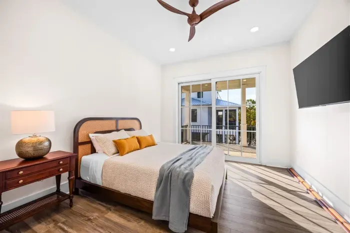 Guest bedroom with queen bed and porch access