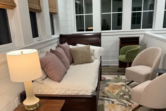 Loft sleeping area with twin bed, trundle, seating, and secretary desk