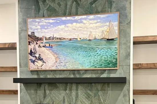 Frame TV transforms into curated artwork above the fireplace, blending technology with design.
