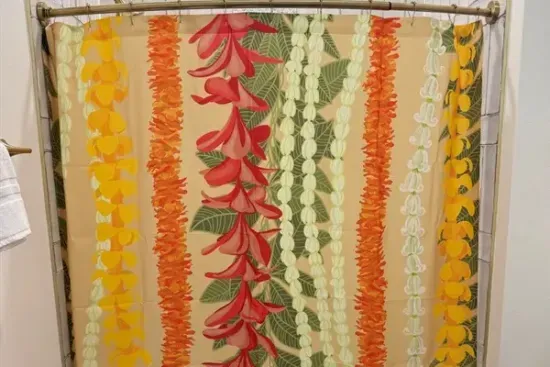 Family bunkroom bath featuring a colorful lei-inspired shower curtain