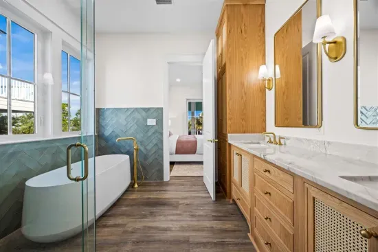 Upstairs primary bathroom with soaking tub, walk-in shower, and double vanities