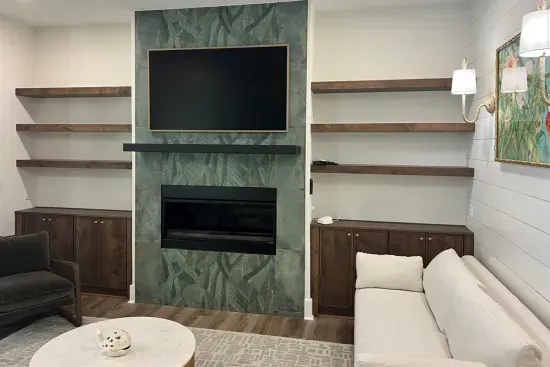 Settle in by the fireplace on a cooler coastal evening, built-in shelving on either side for books, games, or décor.