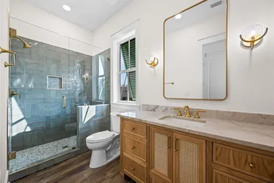 Step into the frameless glass enclosure — this guest bath has its own distinct personality.