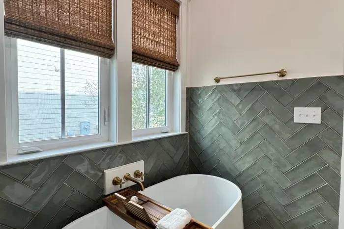 Downstairs Master Bath w/ soaking tub with caddy/tray and woven wood shades