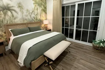 Settle in for the night under the ceiling fan, the mural glowing softly and the room all to yourselves.