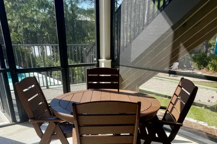 Covered outdoor dining for four—ideal for poolside snacks or as extended seating, expanding total dining capacity at the main house to 16 guests