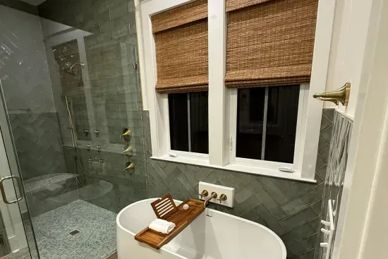 Draw a bath at night, or turn on the shower head, handheld wand, and body jets for a spa day at home, framed by Lagoon penny tile with sea-glass hues — plus a freestanding tub for soaking.